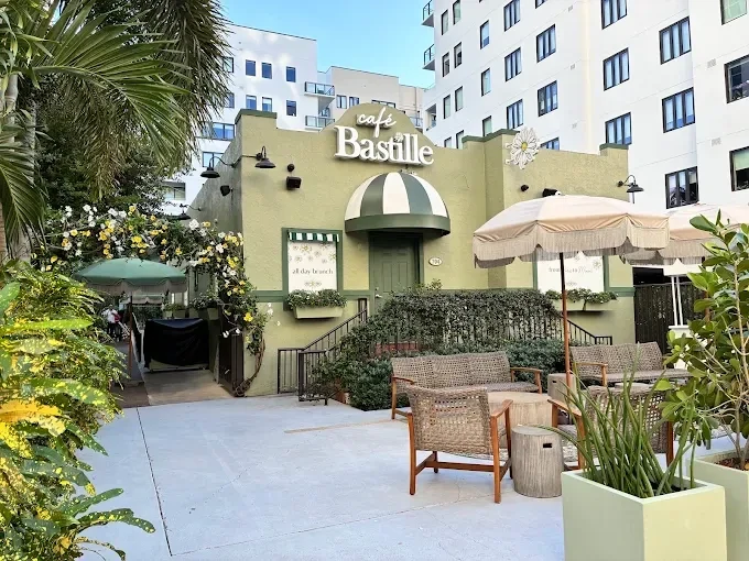 Café Bastille's landscaped terrace and storefront in Fort Lauderdale