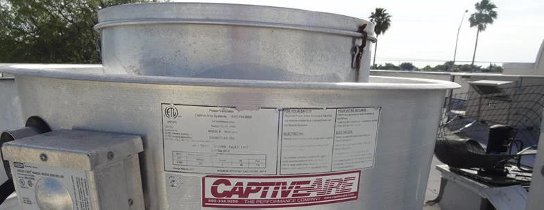 Rooftop kitchen exhaust fan with a metal housing
